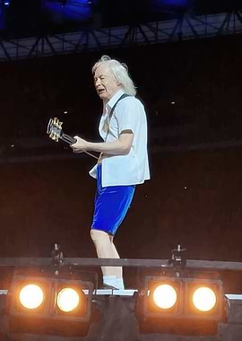 Angus Young performing on stage