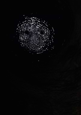 Raindrops in a Puddle at Night