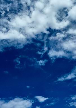 Deep Blue Sky with Soft White Clouds