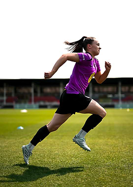 Female Soccer Player Running on Field