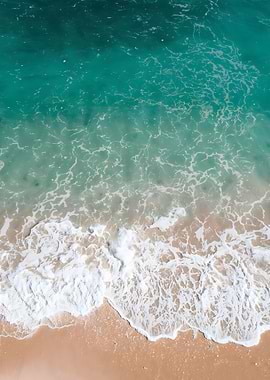 Aerial View of green Ocean water white foam on sandy Beach