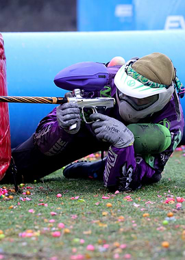 Paintball Player Aiming Gun on Field