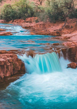 Waterfall cascading over red rock landscape
