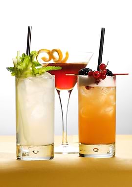 Three colorful cocktails on a table