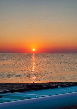 Sunrise over the ocean with paddleboard