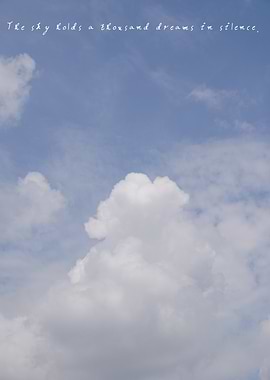 The vast expanse of sky holds delicate clouds, a reminder of the dreams it keeps unspoken.