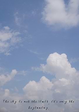 Bright blue sky with soft white clouds drifting across.