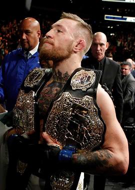 Conor McGregor with Championship Belts