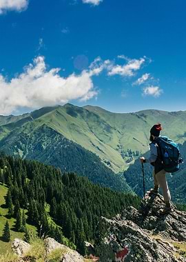 Hiker on mountain peak with backpack
