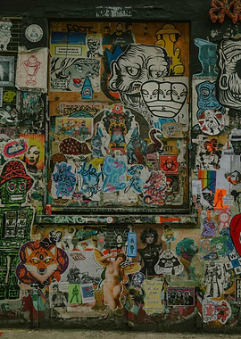 Sticker-covered wall with diverse imagery