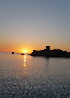 Sunset over the sea with island, Andros, Cyclades, Greece