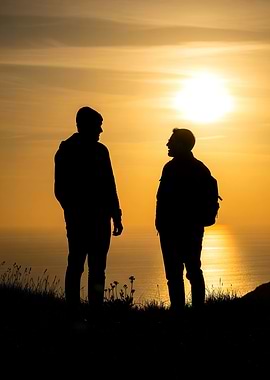 Silhouette of two people at sunset