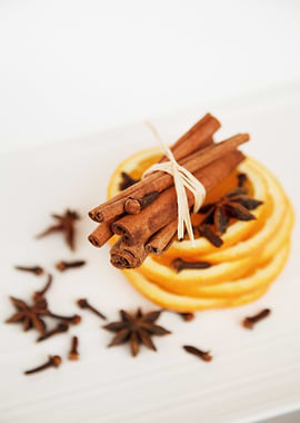 Cinnamon sticks, orange slices, and spices