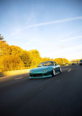 Teal Mazda Miata on Highway