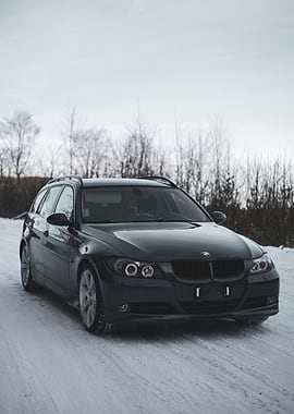 Dark BMW Wagon in Winter Landscape