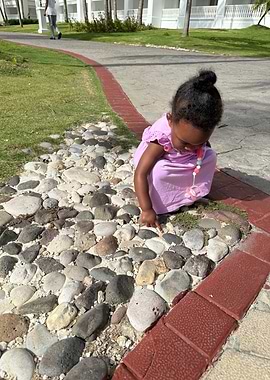 Toddler playing with rocks outdoors