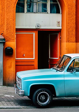 Blue Truck parked near orange building