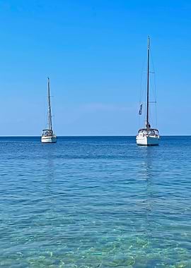 Two Sailboats on Calm Blue Water