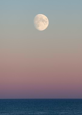 Moon over the ocean at dusk