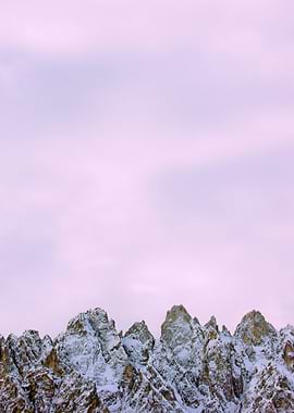 Snowy Mountain Peaks Under Pale Sky