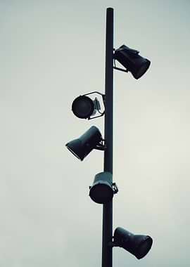 Spotlight Pole Against Overcast Sky