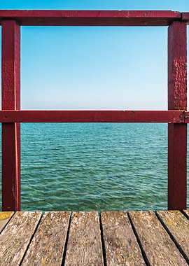 Red pier railing overlooking the ocean