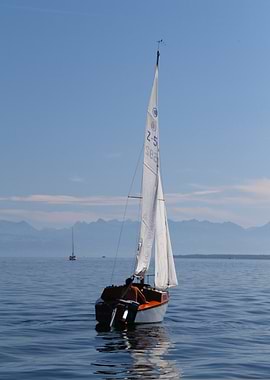 Sailboat on calm water, blue sky