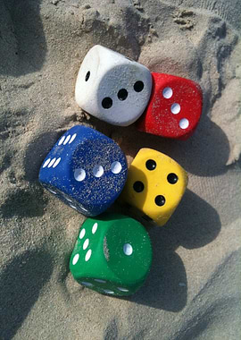 Colorful Dice on Sand