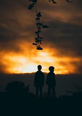 Silhouette of two children at sunset