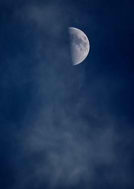 Half Moon in Cloudy Sky
