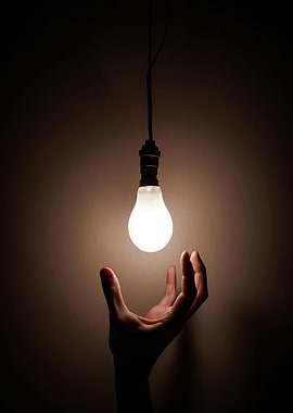Hand Reaching for Light Bulb
