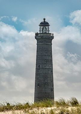 Tall Lighthouse Against Cloudy Sky