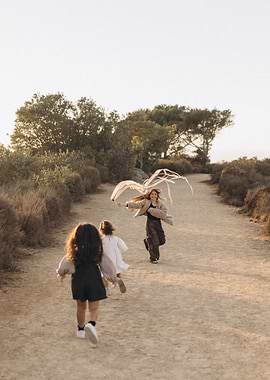Children running with a kite outdoors