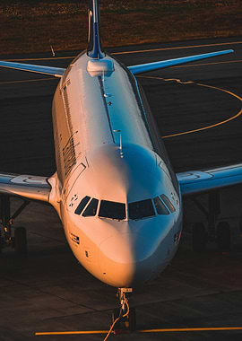 Airbus A320 on the runway at sunset