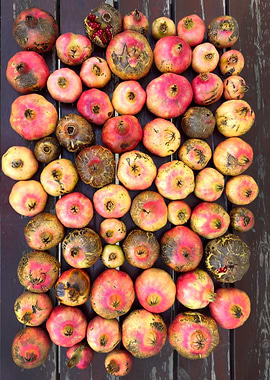 Pomegranates on Dark Wood Surface