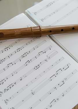 Wooden flute on sheet music