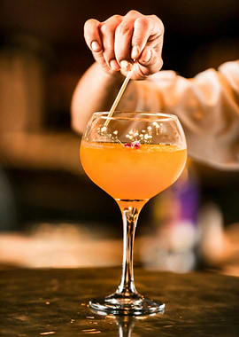 Orange Cocktail with Floral Garnish