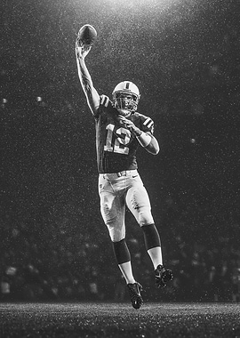 Football Player Catching Ball in Rain