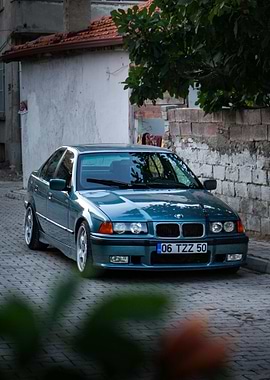 Teal BMW E36 on Cobblestone Street
