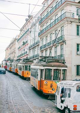 Lisbon Trams on Cobblestone Street