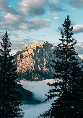 Mountain peak with clouds and trees