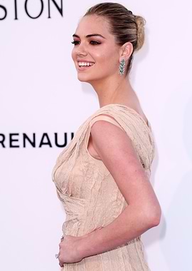 Kate Upton smiling in beige dress