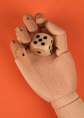 Wooden Hand Holding a Dice