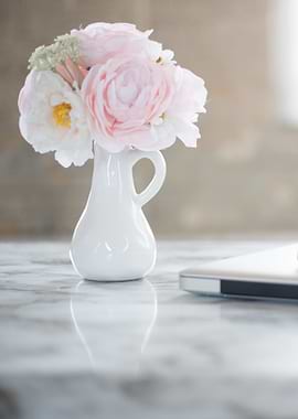 Floral arrangement in white vase