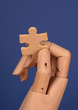 Wooden Hand Holding Puzzle Piece