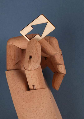 Wooden Hand Holding Abstract Shape