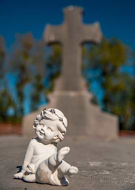 Angel Statue with Cross in Background