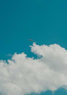 Airplane in Blue Sky with Clouds
