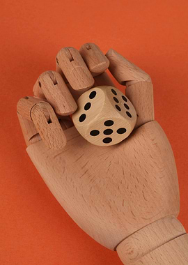Wooden Hand Holding a Dice