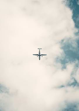 Airplane in Cloudy Sky